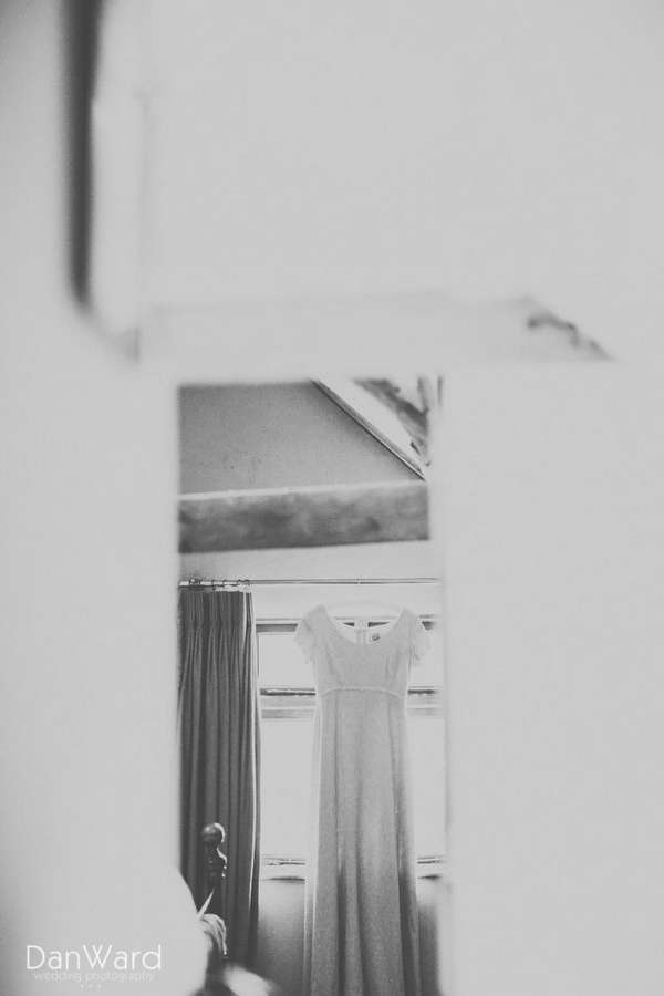 Wedding photographer cornwall frames a wedding dress