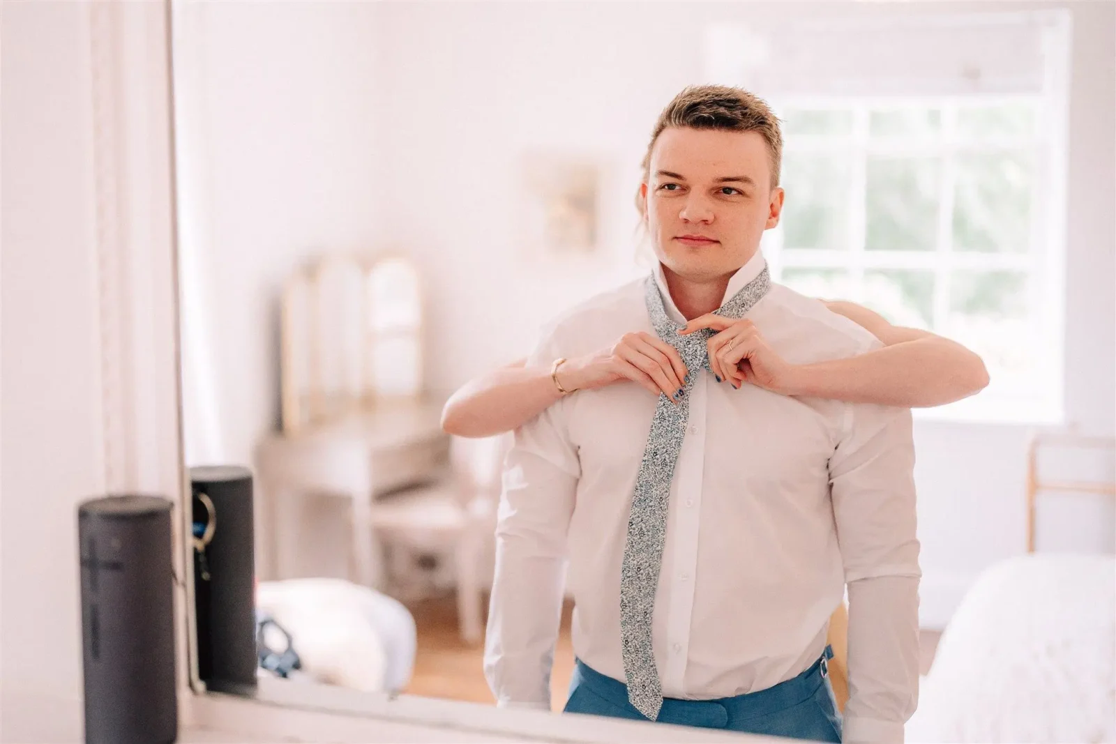 Chloe straightening Ben’s tie