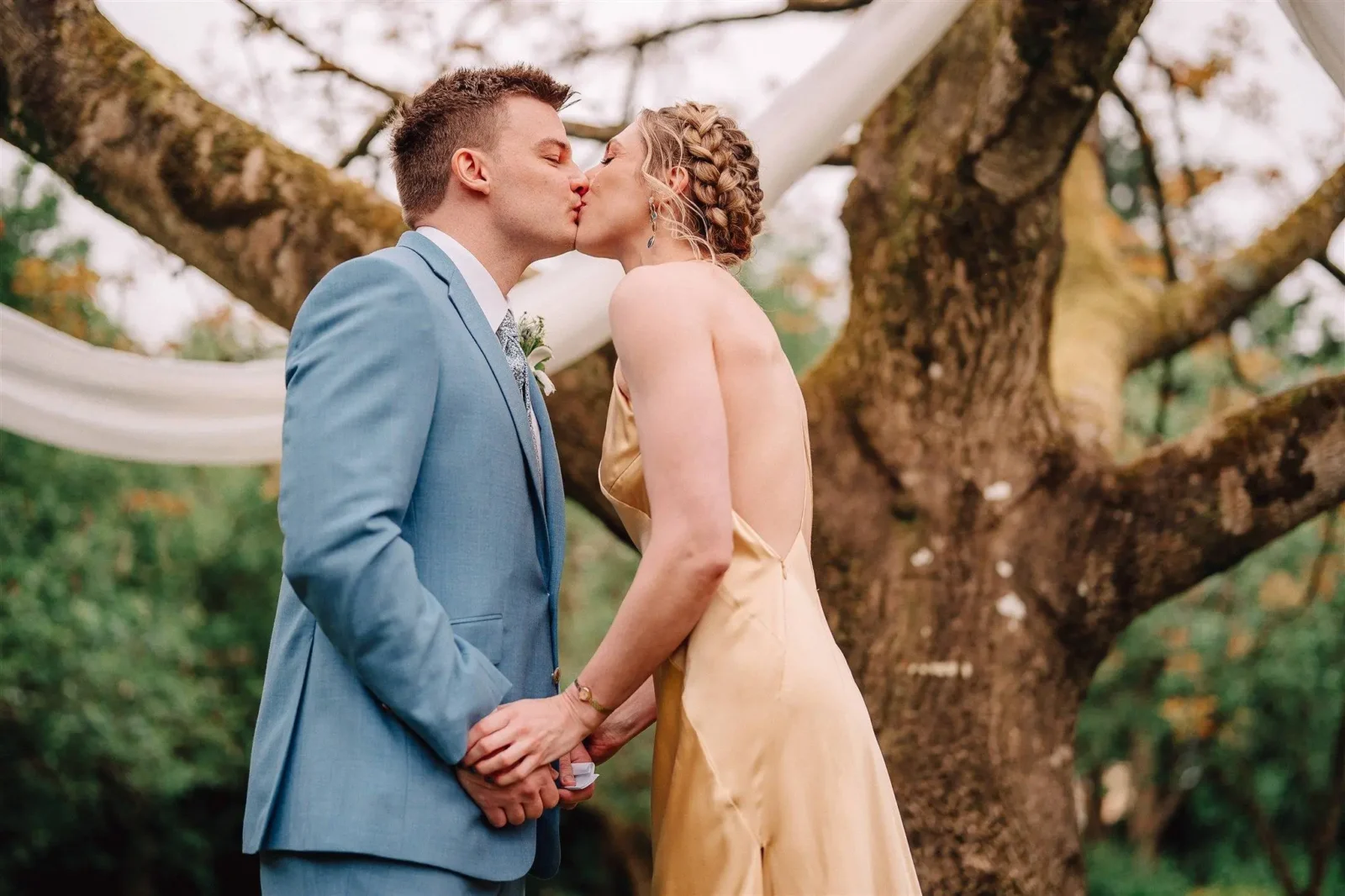 Ben and Chloe kissing under the walnut tree